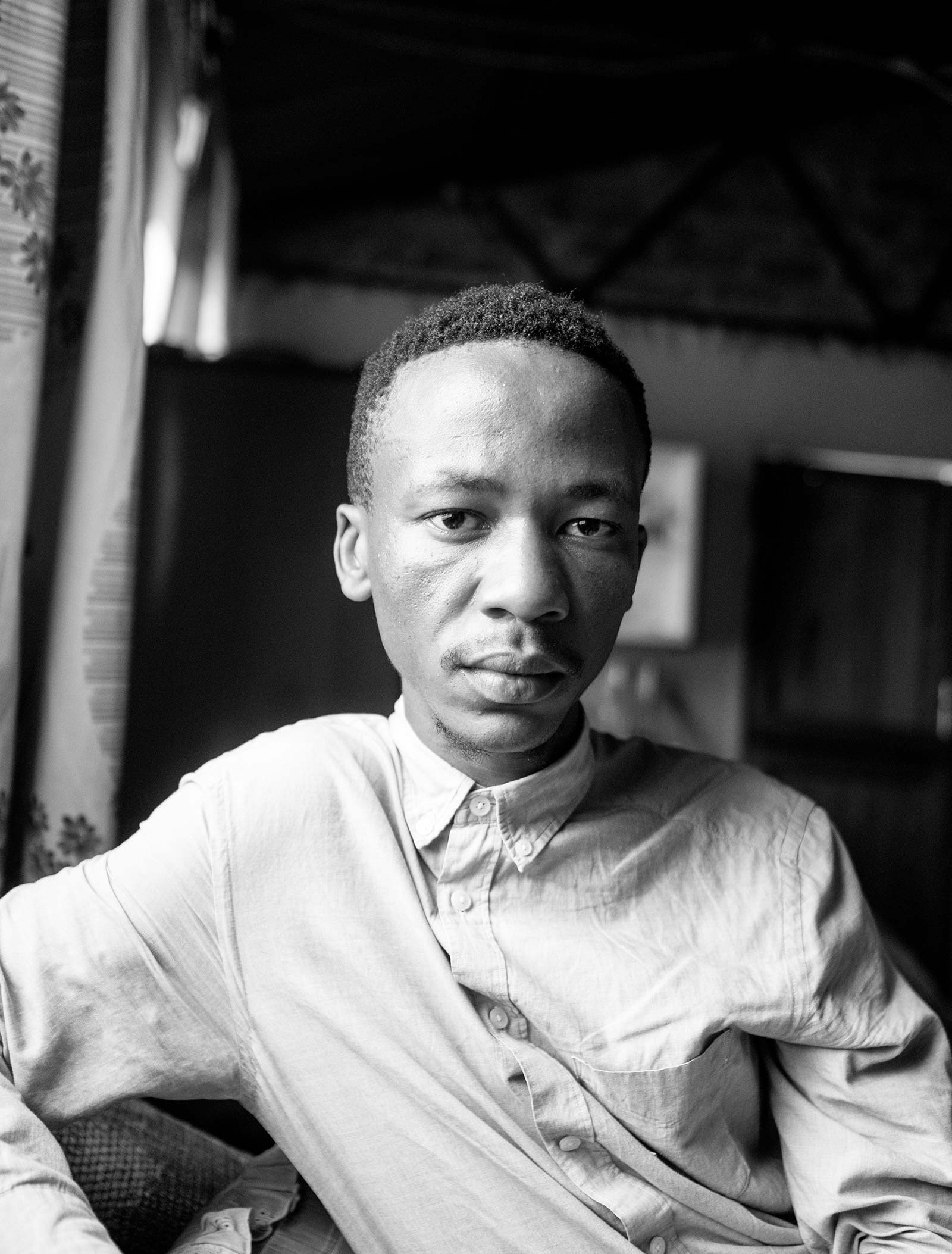 Black and white portrait of Lindokuhle Sobekwa, looking directly at the camera